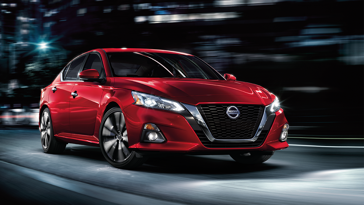 Imagen de Nissan Altima rojo en movimiento de noche