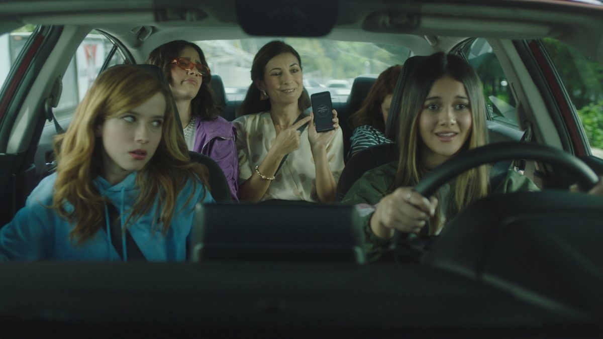 Vista de jóvenes conduciendo un Nissan mientras la mamá tiene activado NissanConnect