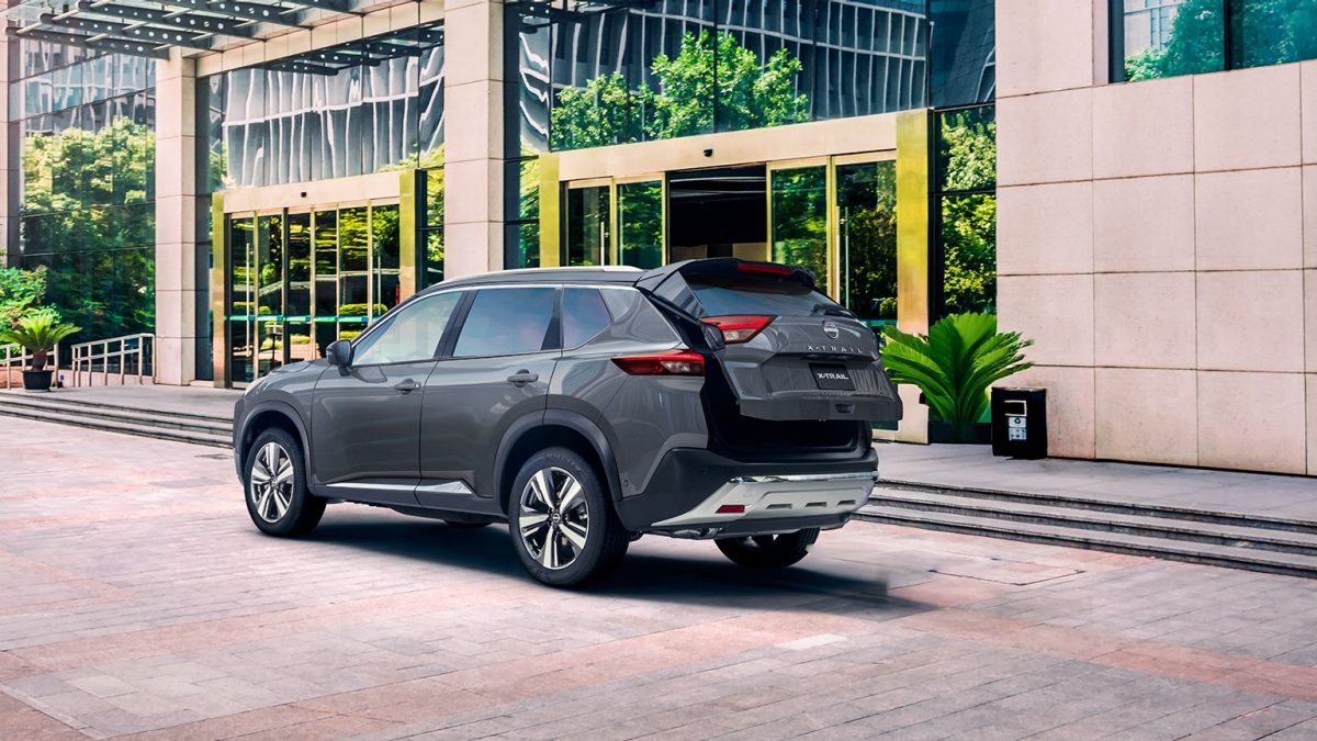 Vista trasera de Nissan X-Trail 2026 con hombre abriendo cajuela con sistema de apertura no touch con amplio espacio de almacenamiento.